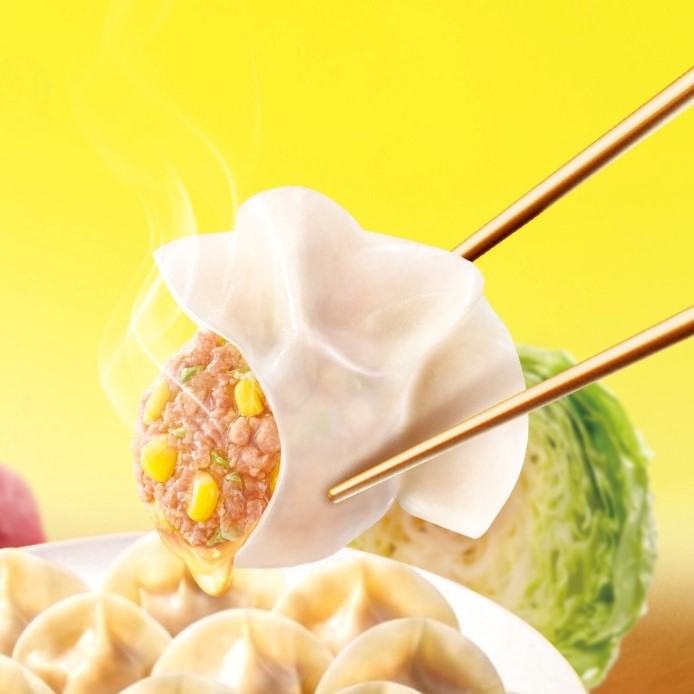 Steaming dumpling held with chopsticks, showing meat and corn filling on a bright yellow background.